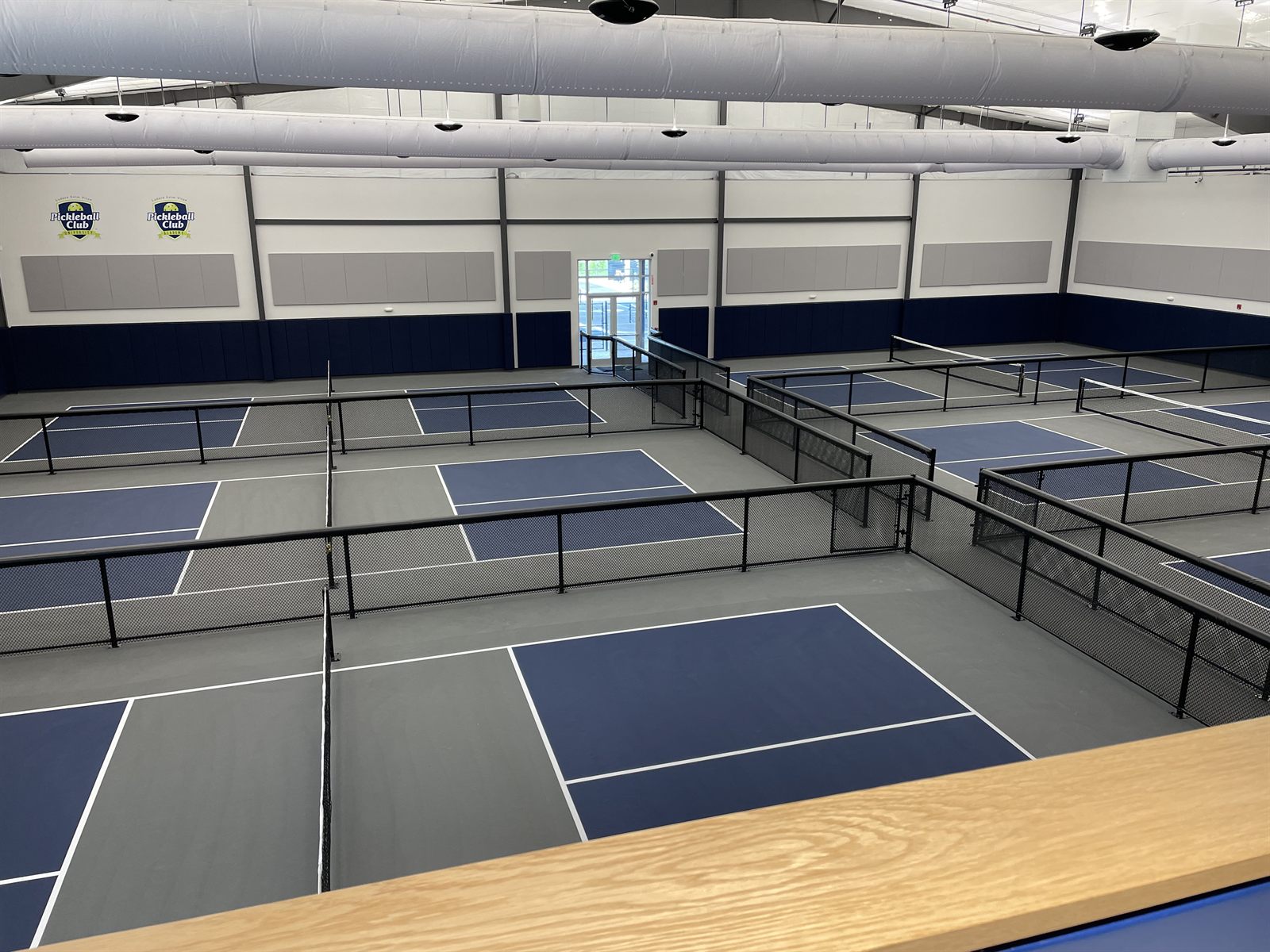 Indoor climate-controlled pickleball courts at The Pickleball Club